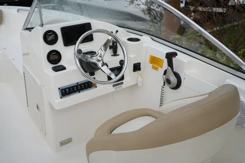Slide: The Image of 2020 Key West 203 DFS boat cockpit with steering wheel and control panel. - 22