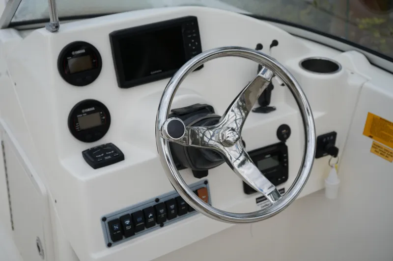 Slide: The Image of Steering console of 2020 Key West 203 DFS boat with gauges and controls. - 23