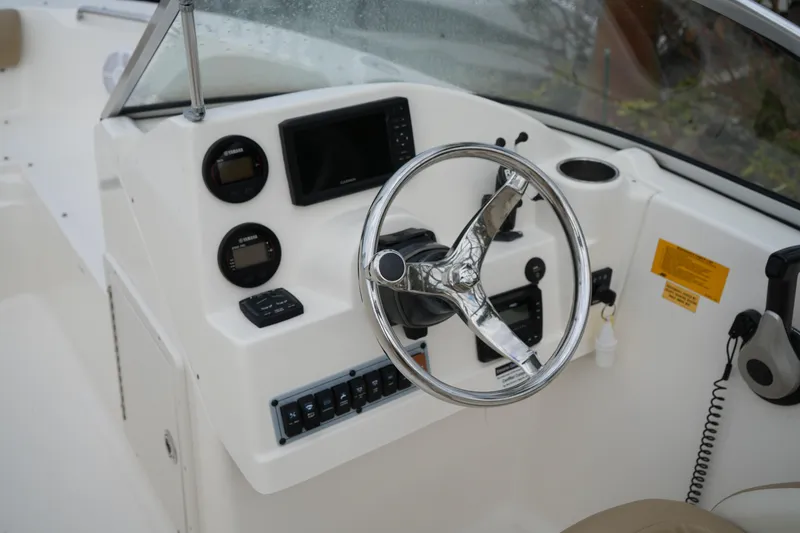 Slide: The Image of Steering console of 2020 Key West 203 DFS boat with gauges and controls. - 24