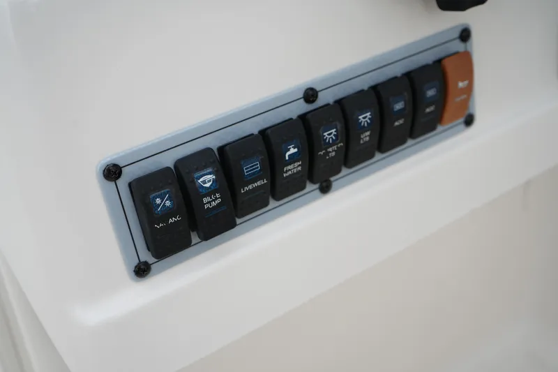 Slide: The Image of Control panel of a 2020 Key West 203 DFS boat with labeled switches. - 27
