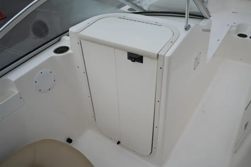 Slide: The Image of 2020 Key West 203 DFS boat interior with storage compartment and cup holder. - 29