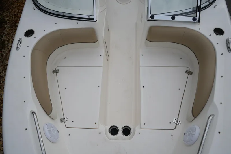 Slide: The Image of 2020 Key West 203 DFS boat interior with beige seating and storage compartments. - 33