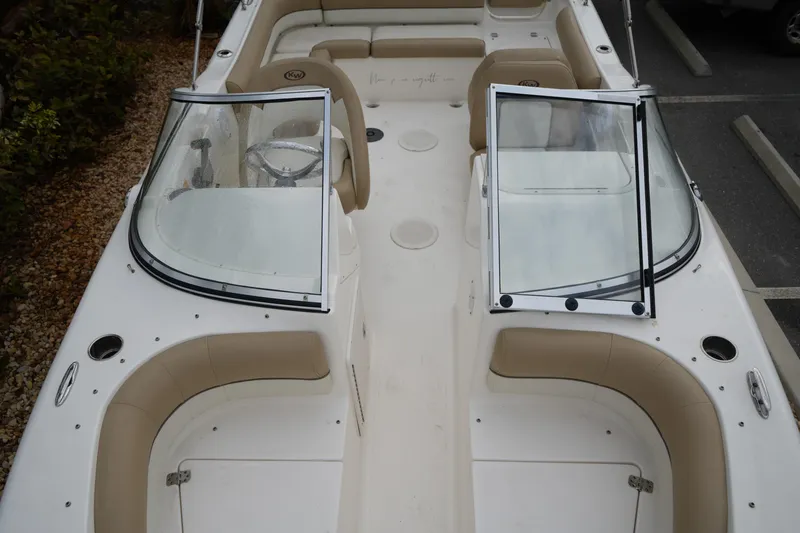 Slide: The Image of 2020 Key West 203 DFS boat interior with beige seating and dual consoles. - 34