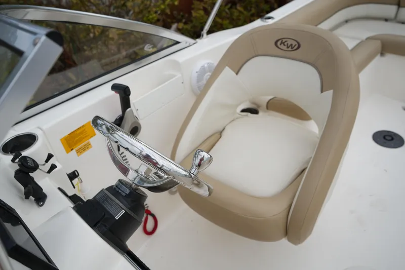 Slide: The Image of Steering area of 2020 Key West 203 DFS boat with beige and white seating. - 36