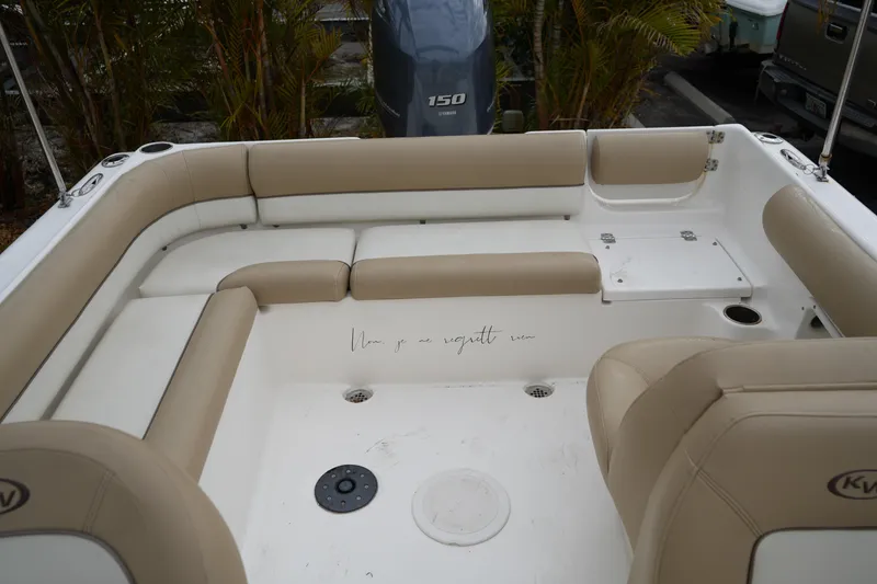 Slide: The Image of 2020 Key West 203 DFS boat interior with beige seating and motor view. - 37