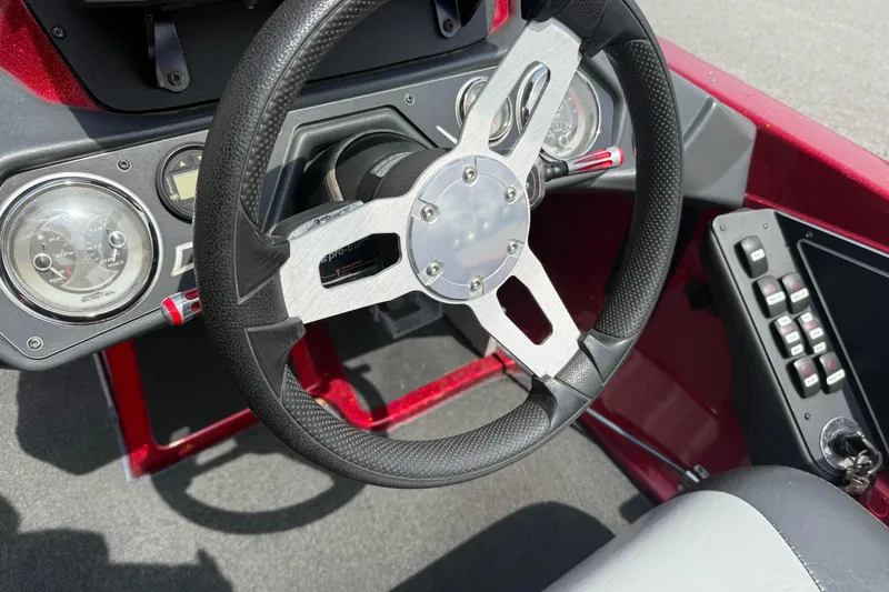 Slide: The Image of Steering wheel and dashboard of a 2017 Skeeter ZX250 boat. - 10