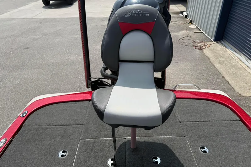 Slide: The Image of 2017 Skeeter ZX250 boat seat with red and gray accents on deck. - 13
