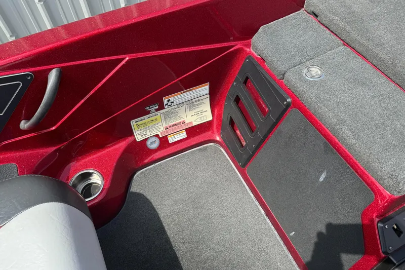 Slide: The Image of 2017 Skeeter ZX250 boat interior with red finish and safety labels. - 14