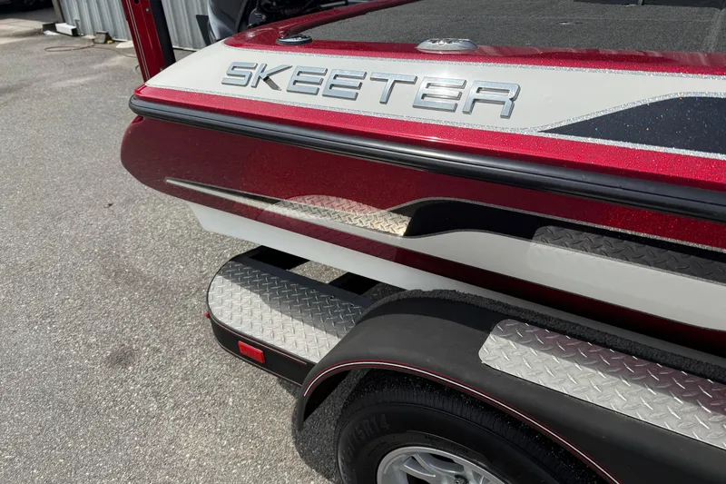 Slide: The Image of 2017 Skeeter ZX250 boat with red and white detailing on a trailer. - 3