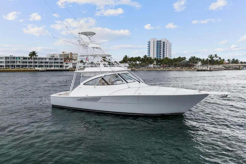 The Image of 2018 Viking 44 Express yacht on water, with cityscape background. - 0