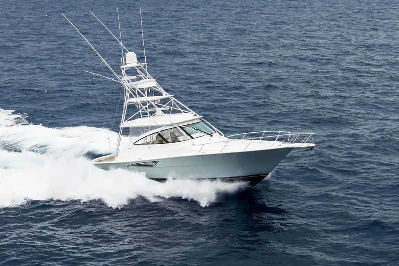 Slide: The Image of 2018 Viking 44 Express yacht cruising on open ocean waters. - 10