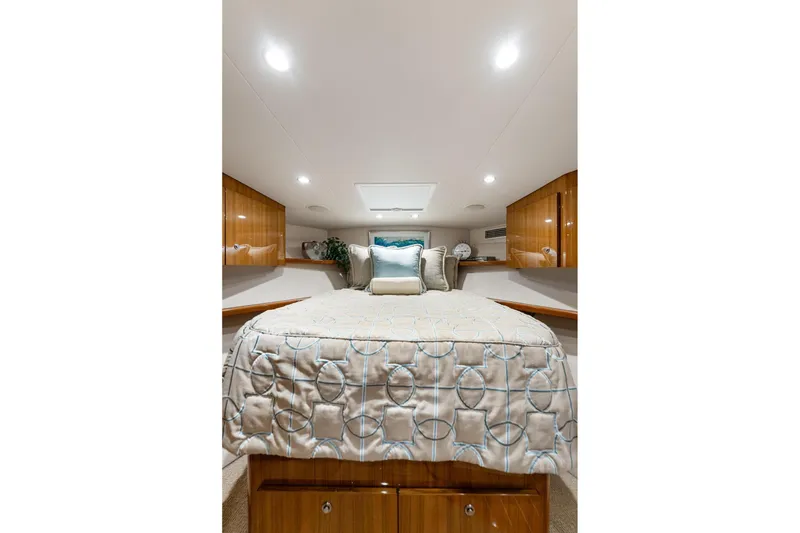 Slide: The Image of Luxurious cabin interior of 2018 Viking 44 Express yacht with elegant bedding and wood cabinetry. - 100
