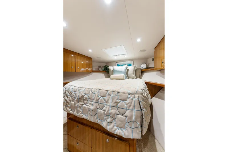 Slide: The Image of Luxurious cabin interior of 2018 Viking 44 Express yacht with elegant bedding and wood cabinetry. - 101