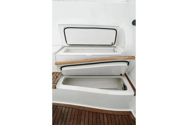 Slide: The Image of Open storage compartments on 2018 Viking 44 Express boat with wooden trim. - 117