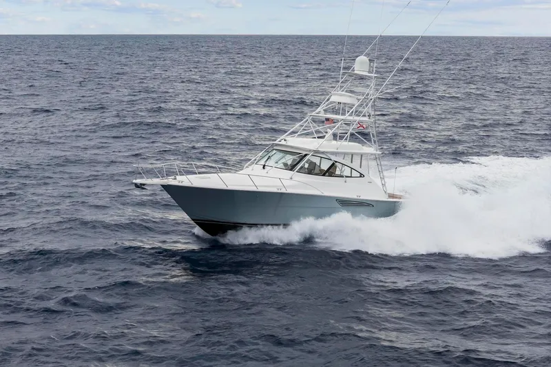 Slide: The Image of 2018 Viking 44 Express yacht cruising on open ocean waters. - 12