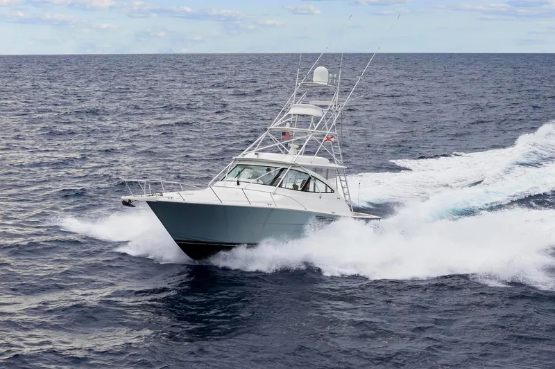 Slide: The Image of 2018 Viking 44 Express yacht cruising swiftly on open ocean waters. - 13