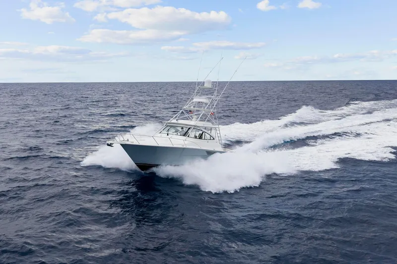 Slide: The Image of 2018 Viking 44 Express yacht cruising swiftly on open ocean waters. - 15