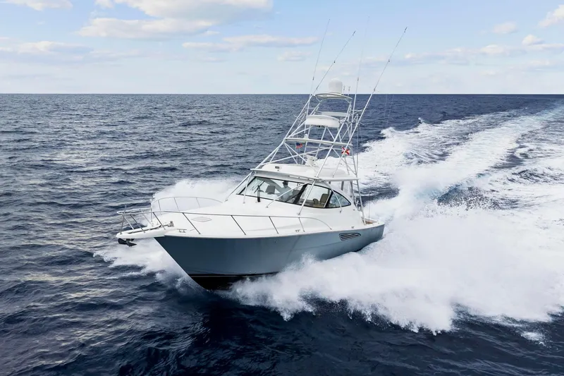 Slide: The Image of 2018 Viking 44 Express yacht cruising swiftly on open ocean waters. - 16