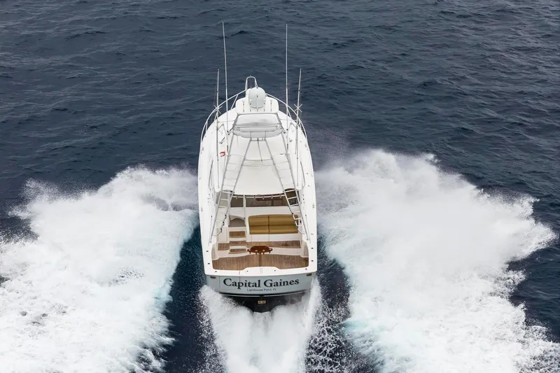 Slide: The Image of 2018 Viking 44 Express yacht cruising on open water, rear view. - 22