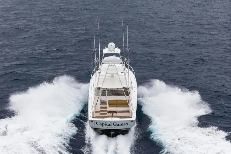 Slide: The Image of 2018 Viking 44 Express yacht cruising on open water, rear view. - 24