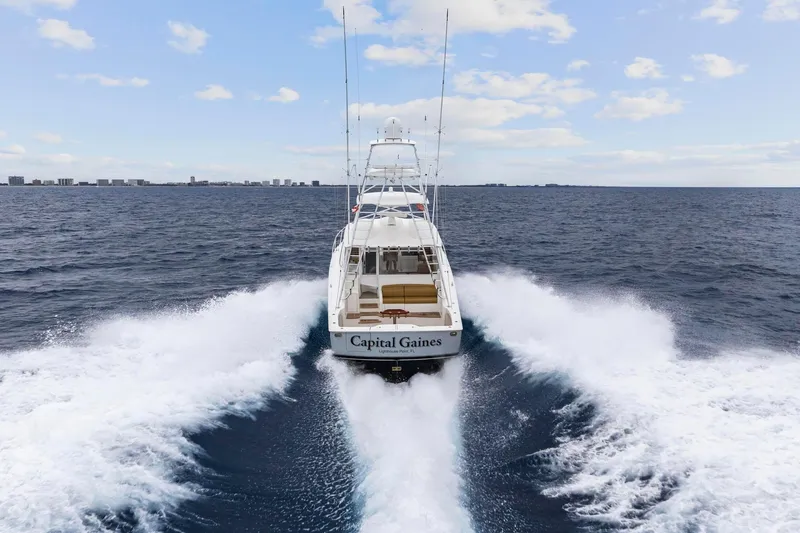 Slide: The Image of 2018 Viking 44 Express yacht cruising on open water, rear view. - 27