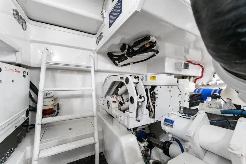 Slide: The Image of Engine room of 2018 Viking 44 Open yacht, featuring Cummins Onan generator and mechanical components. - 106