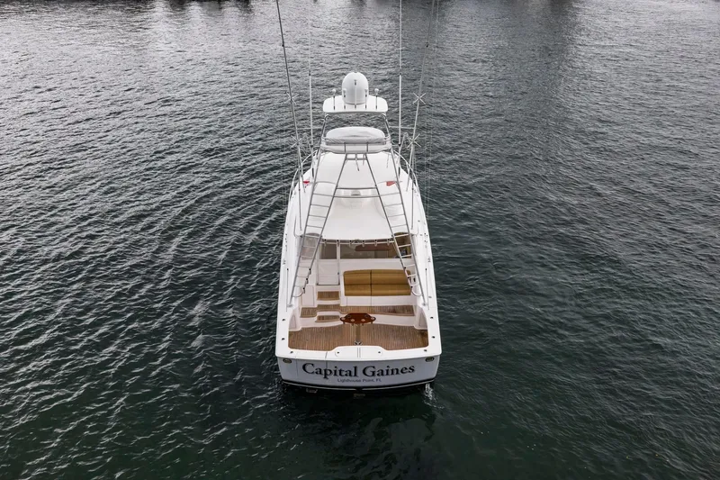 Slide: The Image of 2018 Viking 44 Express yacht on water, rear view, named "Capital Gaines". - 36