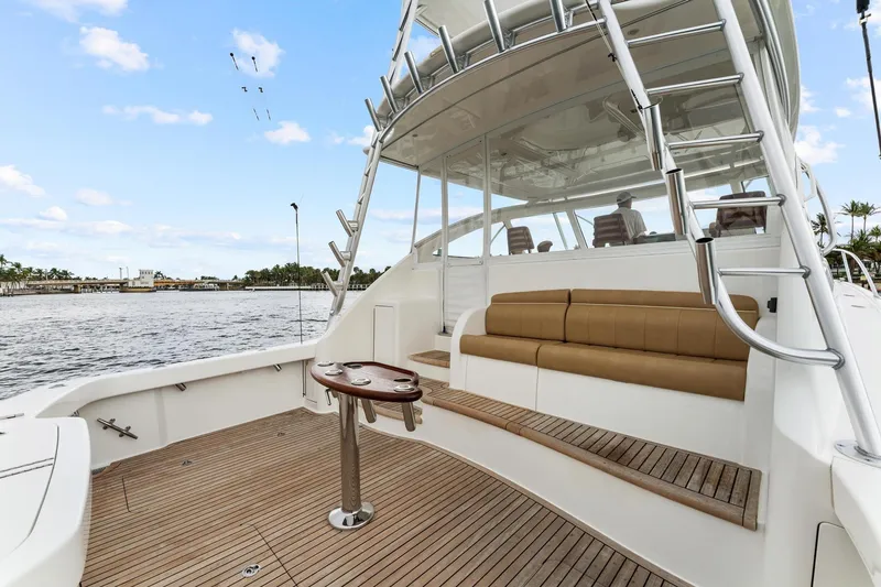 Slide: The Image of 2018 Viking 44 Express yacht with spacious deck and seating, docked by the water. - 45