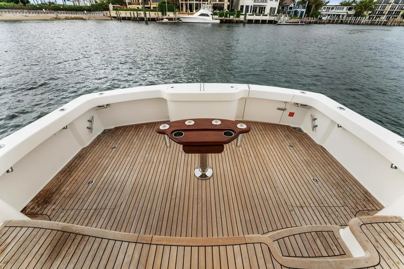 Slide: The Image of 2018 Viking 44 Express yacht deck with wooden flooring and central table. - 53