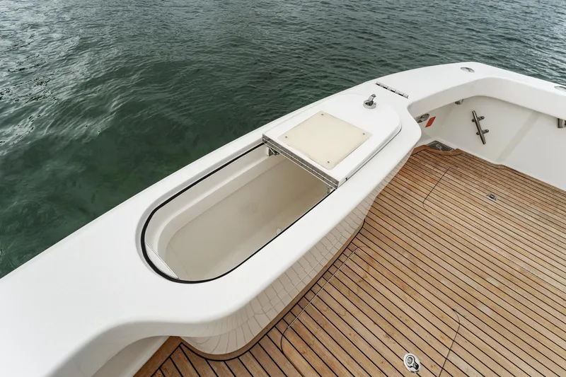 Slide: The Image of 2018 Viking 44 Express boat deck with teak flooring and storage compartment. - 58