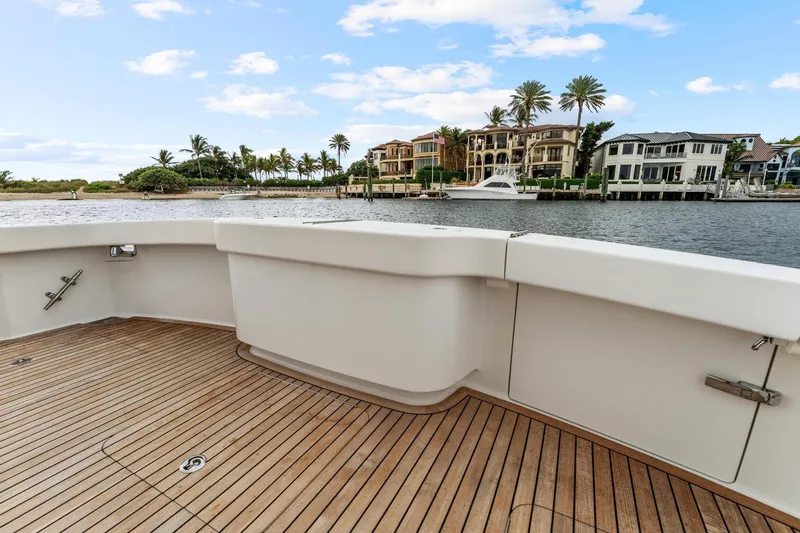 Slide: The Image of 2018 Viking 44 Express yacht deck with waterfront view and luxury homes. - 59