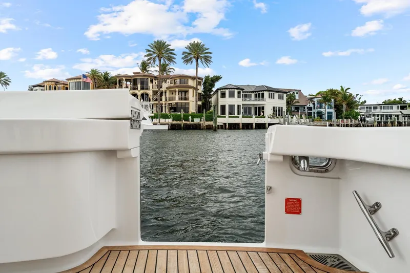 Slide: The Image of View from a 2018 Viking 44 Express yacht, overlooking waterfront homes and palm trees. - 60