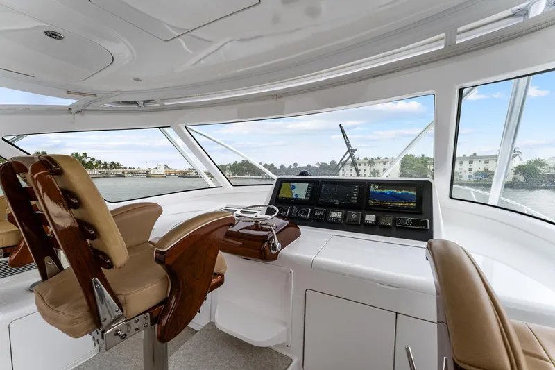 Slide: The Image of 2018 Viking 44 Express yacht helm with leather seats and advanced navigation systems. - 67