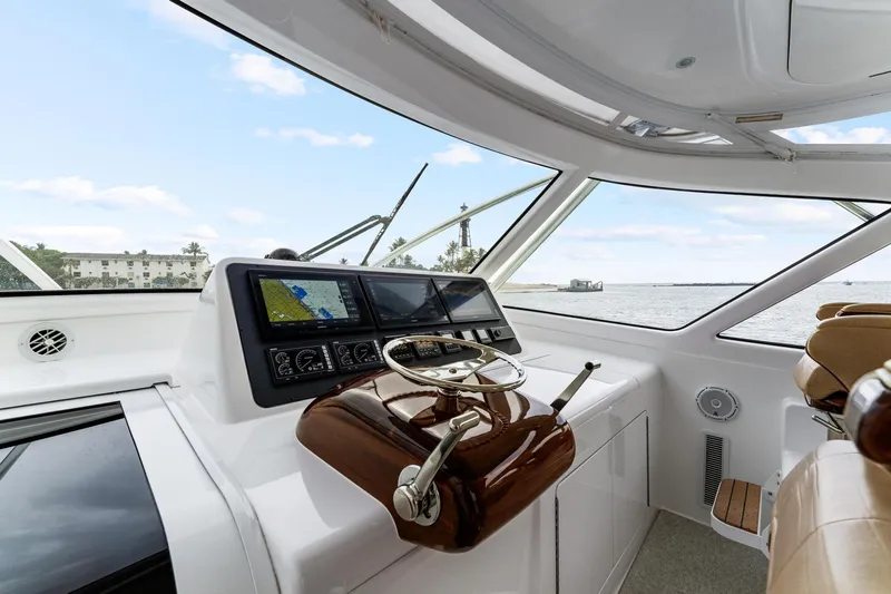 Slide: The Image of 2018 Viking 44 Express yacht helm with navigation screens and ocean view. - 70