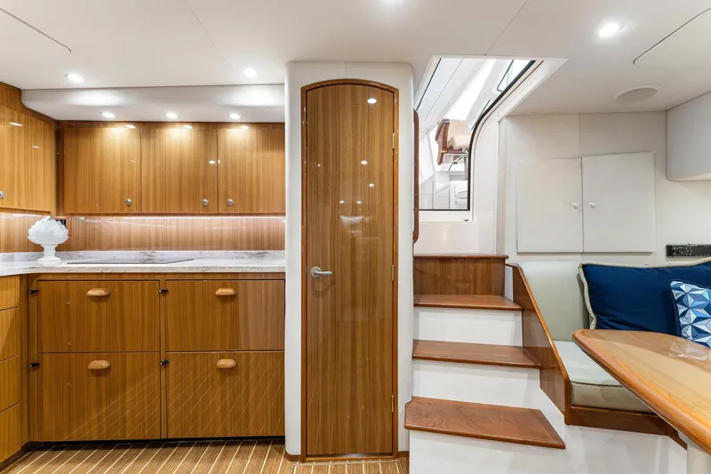 Slide: The Image of Luxurious interior of 2018 Viking 44 Express yacht with wooden cabinetry and seating area. - 84