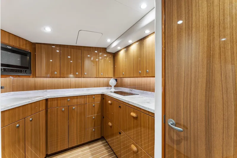 Slide: The Image of Luxurious wooden kitchen interior of 2018 Viking 44 Express yacht with modern amenities. - 85