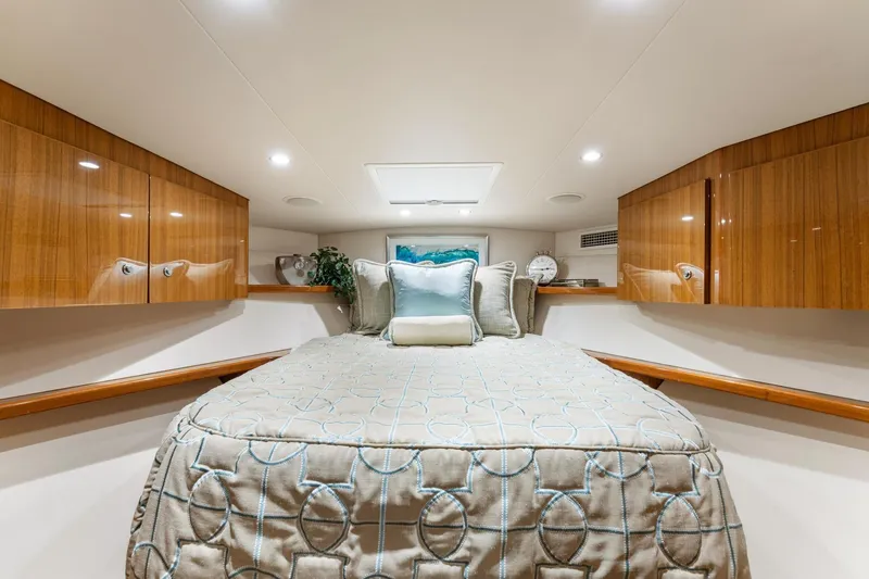 Slide: The Image of Luxurious cabin interior of 2018 Viking 44 Express yacht with elegant bedding and wood cabinetry. - 88