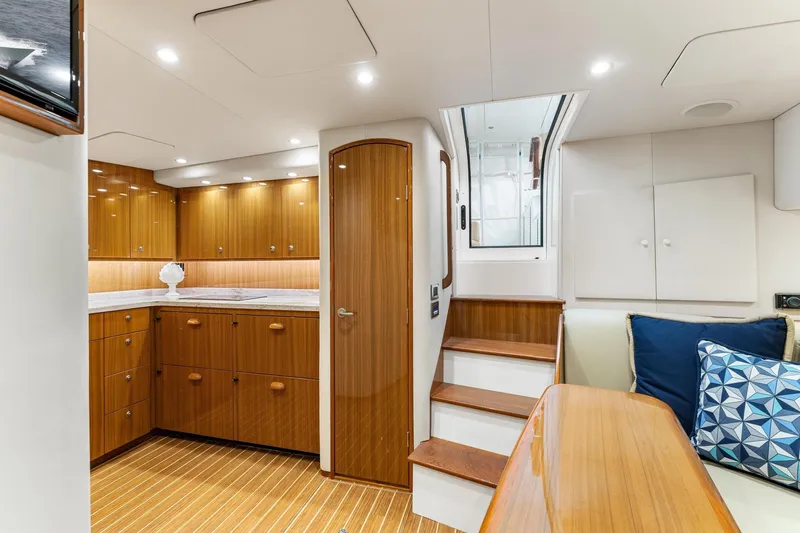 Slide: The Image of Luxurious interior of 2018 Viking 44 Express yacht with wooden cabinetry and modern lighting. - 91