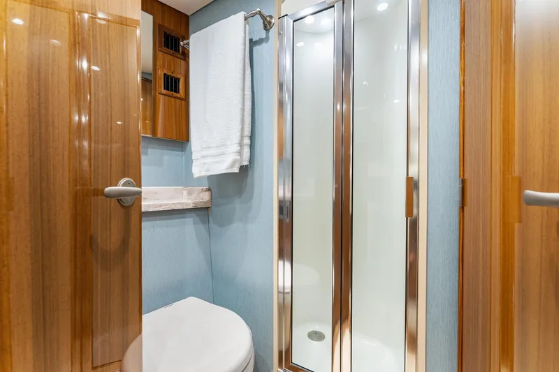 Slide: The Image of Luxurious bathroom interior of 2018 Viking 44 Express yacht with shower and wooden accents. - 93