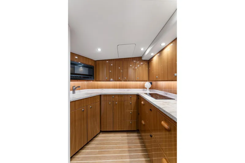 Slide: The Image of Luxurious kitchen interior of 2018 Viking 44 Express yacht with wood cabinetry and modern appliances. - 94