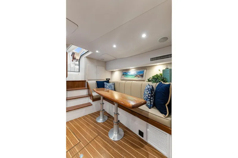 Slide: The Image of Interior of 2018 Viking 44 Express yacht with elegant seating and wooden table. - 98