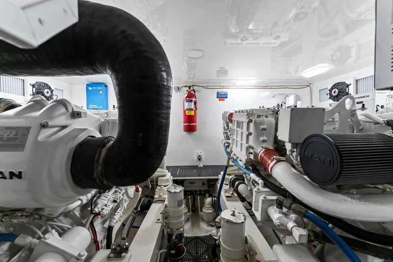 Slide: The Image of Engine room of a 2018 Viking 44 Open yacht, featuring MAN engines and safety equipment. - 101