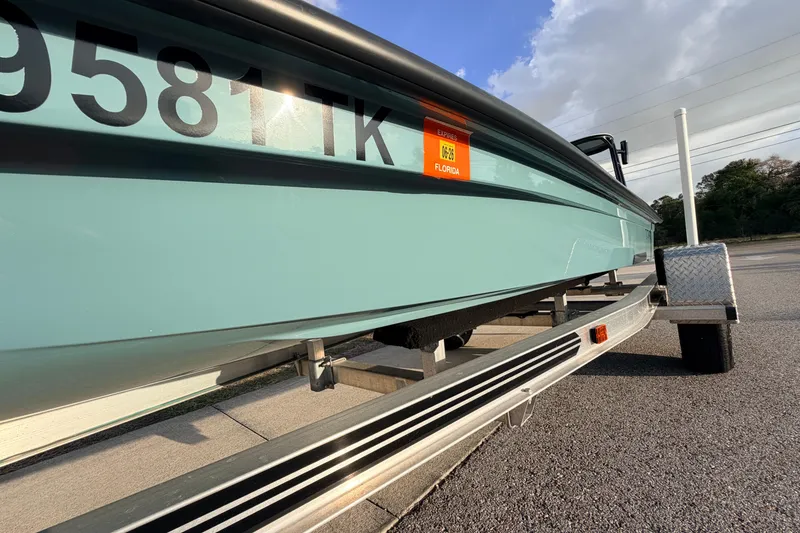 Slide: The Image of 2023 Dorado 16 Skiff boat on trailer, Florida registration visible. - 12