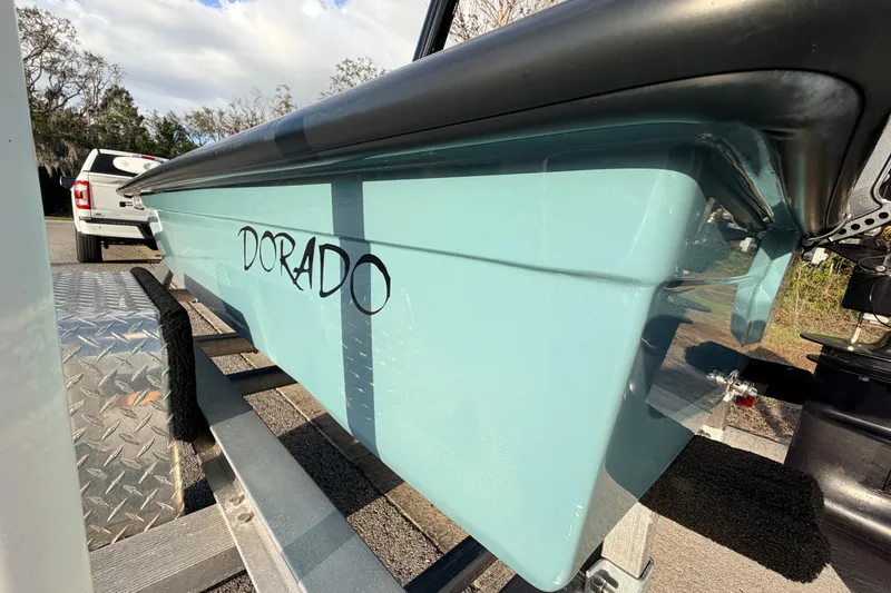 Slide: The Image of 2023 Dorado 16 Skiff boat on trailer, showcasing sleek design and light blue hull. - 13