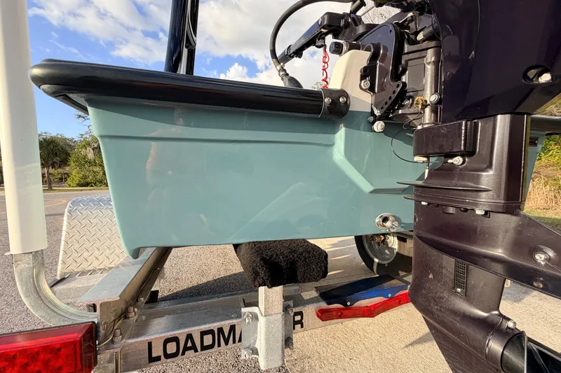 Slide: The Image of 2023 Dorado 16 Skiff boat on Loadmaster trailer, featuring outboard motor and blue hull. - 14