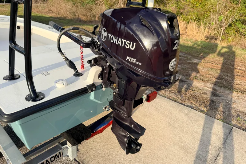 Slide: The Image of 2023 Dorado 16 Skiff with Tohatsu outboard motor, parked on a trailer. - 19