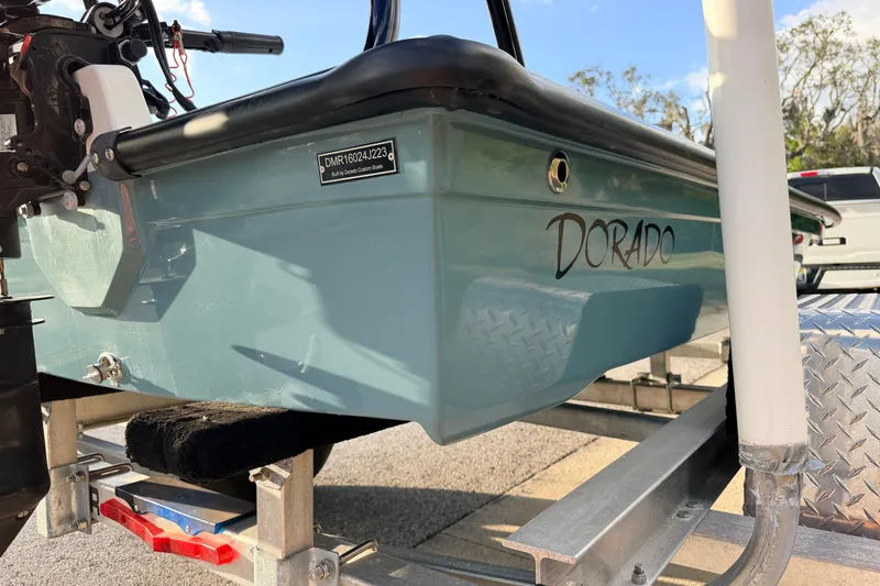 Slide: The Image of 2023 Dorado 16 Skiff boat on trailer, showcasing sleek design and branding. - 21