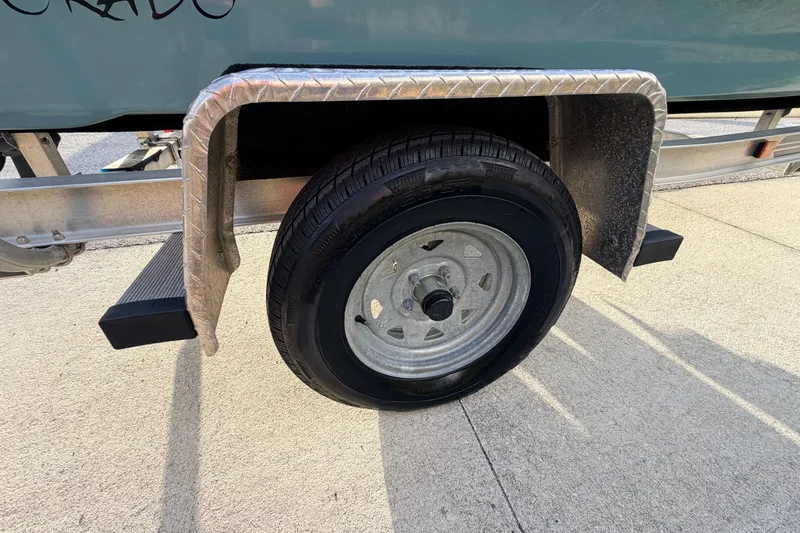 Slide: The Image of Trailer wheel of 2023 Dorado 16 Skiff boat on pavement. - 22
