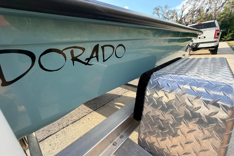 Slide: The Image of 2023 Dorado 16 Skiff boat on trailer, close-up view with logo. - 23