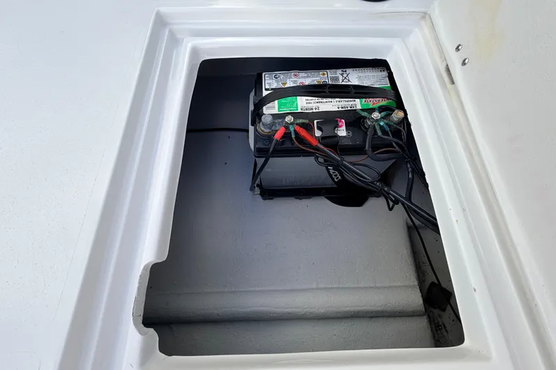 Slide: The Image of Battery compartment of 2023 Dorado 16 Skiff boat, featuring a securely installed marine battery. - 43